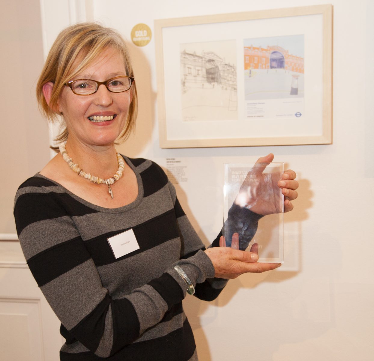 Ruth pictured with her AOI award for her commissioned piece on Smithfield Market